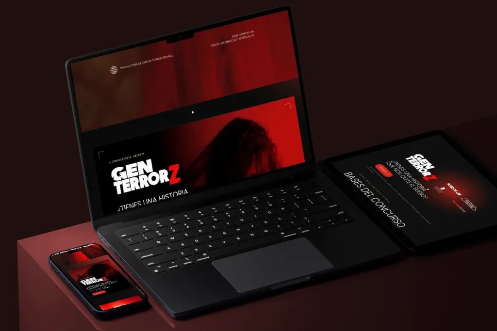 Web de Horror Lab en un portátil, una tablet y un móvil sobre fondo rojo oscuro